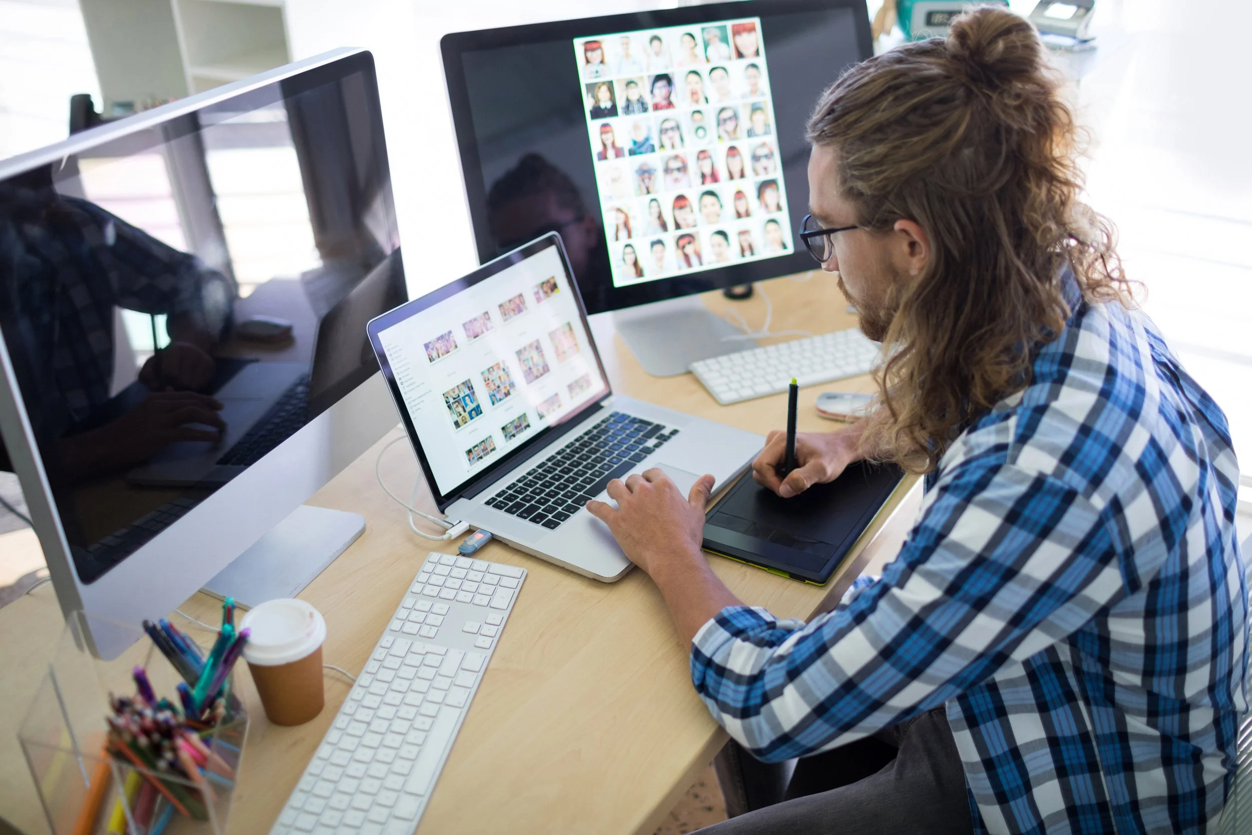 man-working-with-multiple-computers-in-an-office-2026-01-09-09-21-00-utc.jpg (Copy)