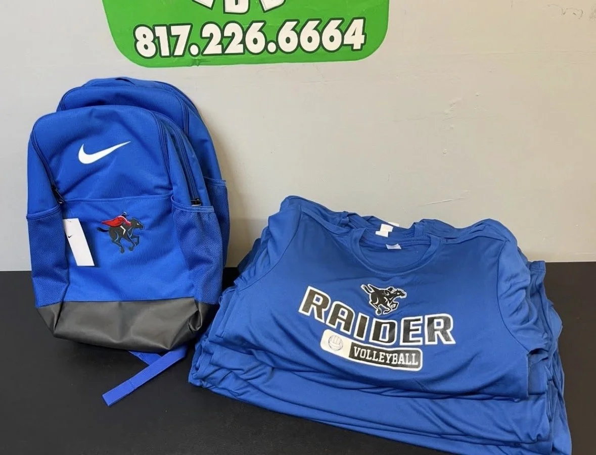 Blue Raider Volleyball team backpack and folded jerseys on a table.