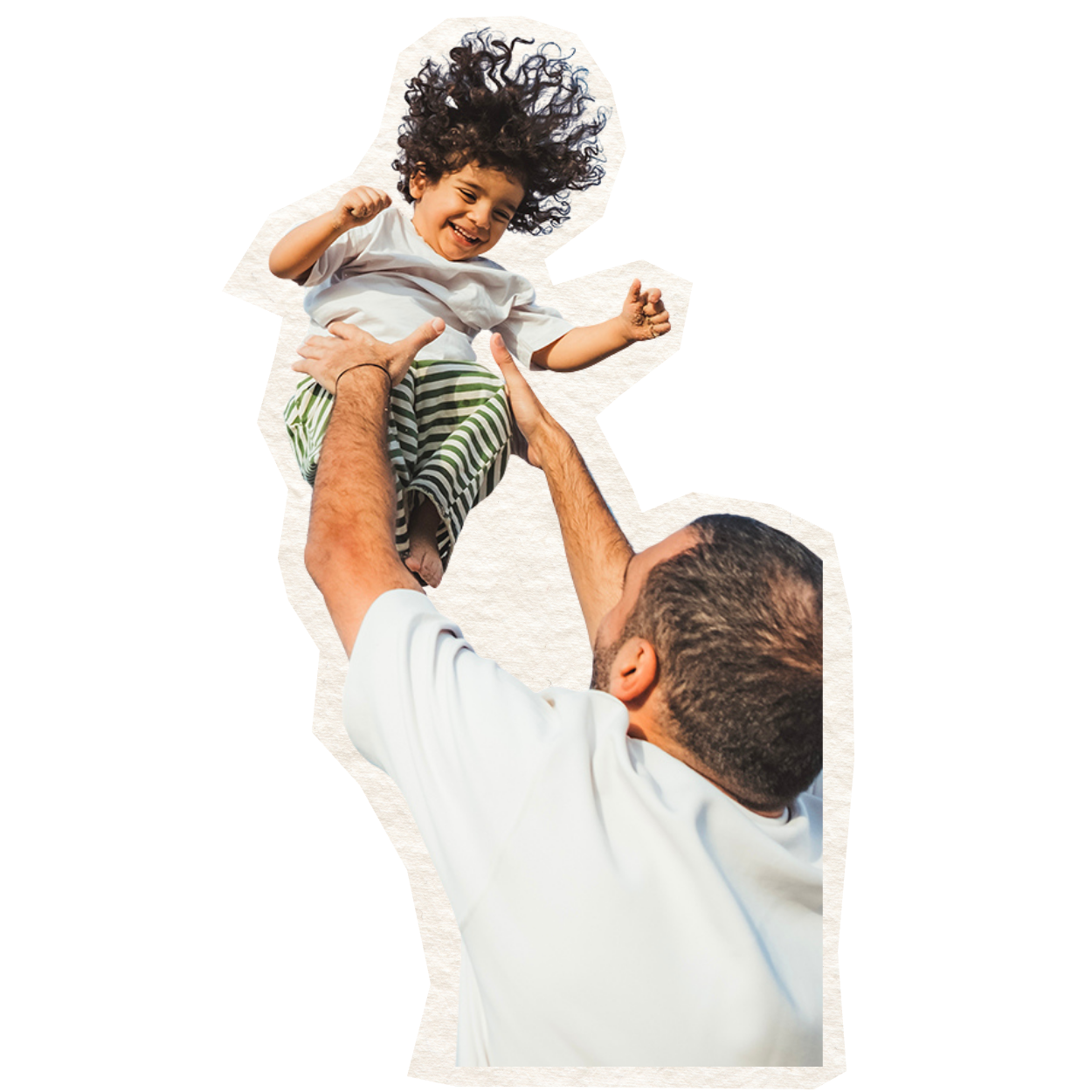 A man lifting a smiling young girl with curly hair in the air outdoors.