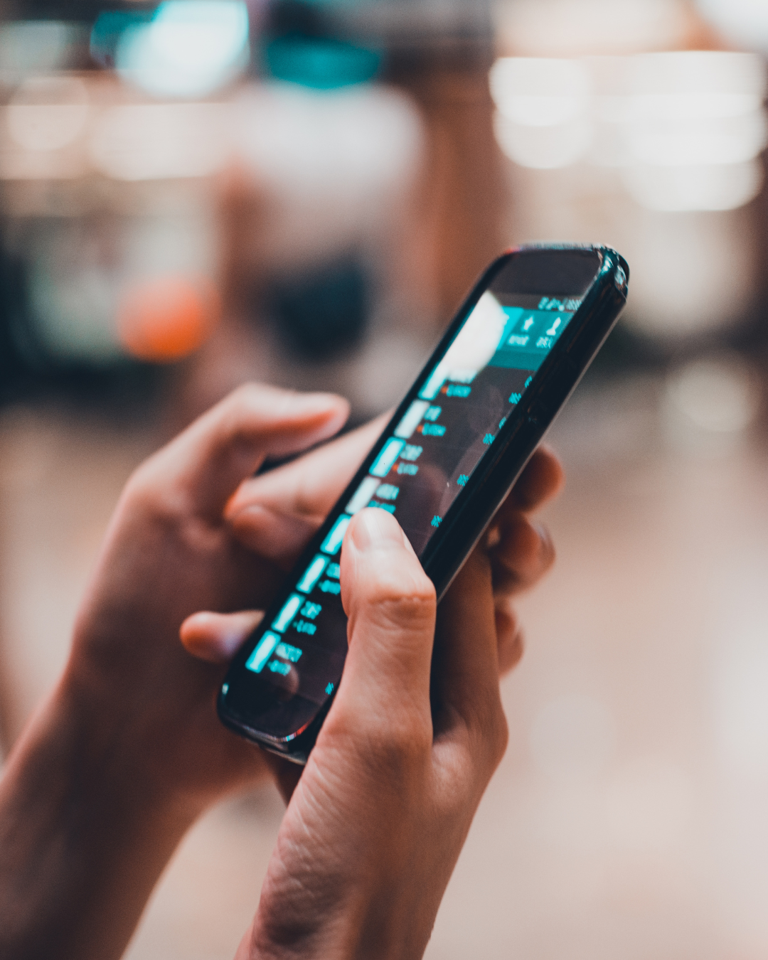 Person holding a smartphone with a fitness tracking app on the screen.