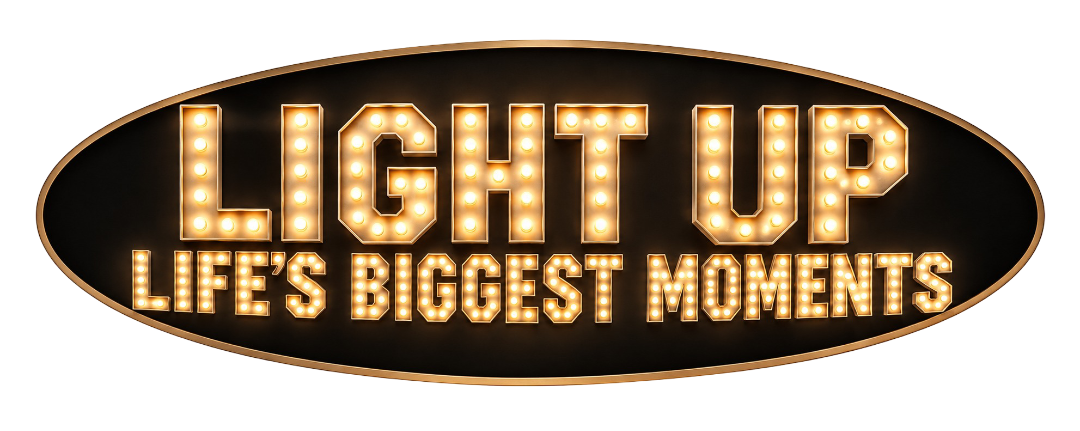 Sign that reads 'Light Up Life's Biggest Moments' with bright marquee-style lights, on an oval black background.