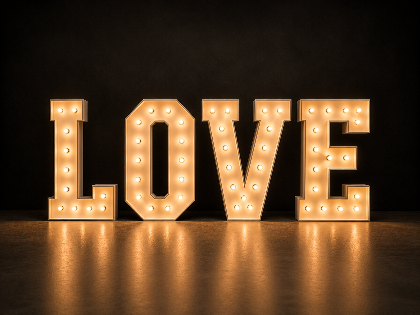 Illuminated marquee sign spelling the word 'LOVE' against a dark background