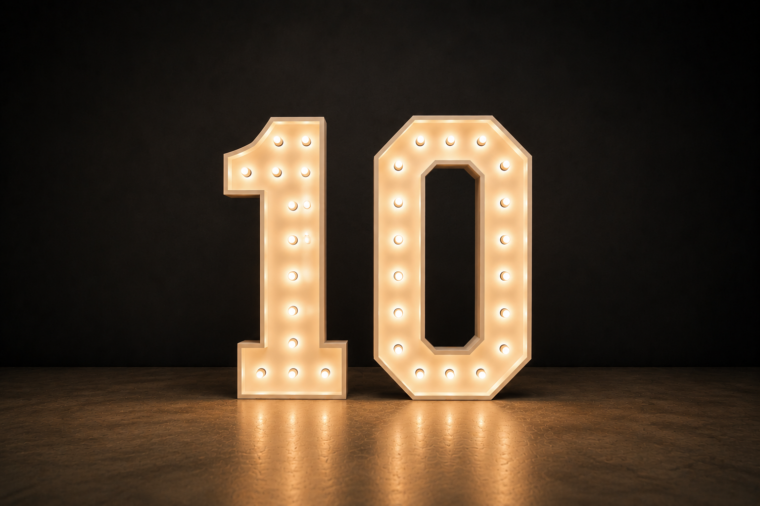 Backlit illuminated marquee number 10 on a dark background.