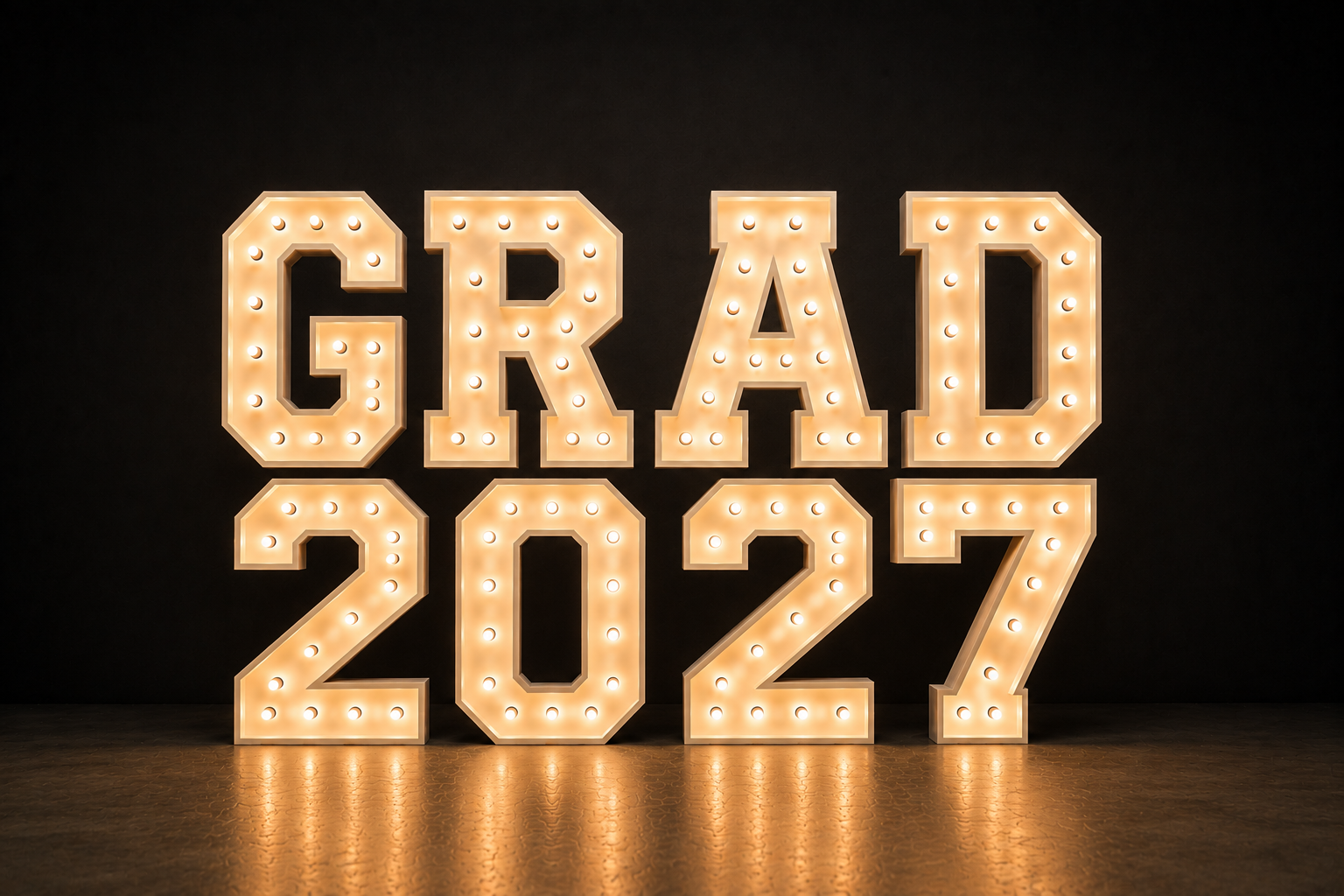 Decorative sign spelling out "GRAD 2027" with illuminated marquee-style lights on a dark background