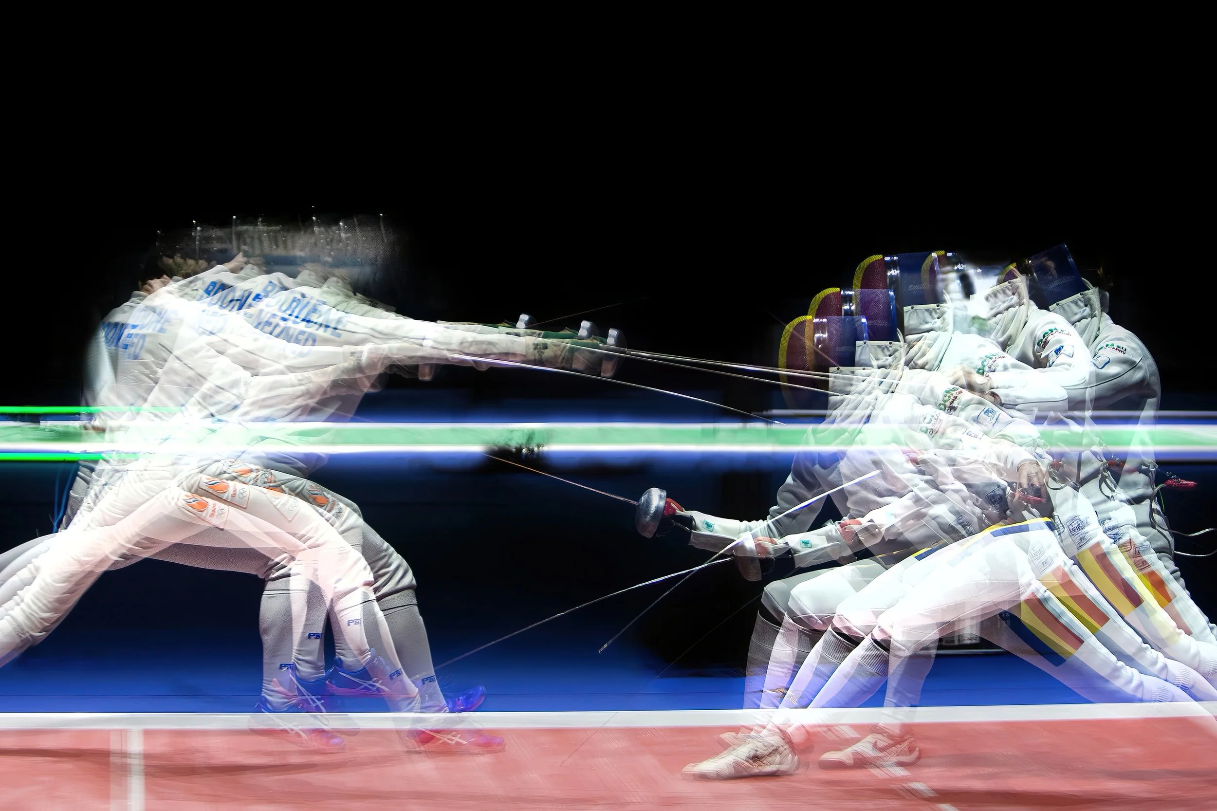 Multiple motion-blurred images of a volleyball player diving on the court, wearing white uniform and knee pads, with a dark background.