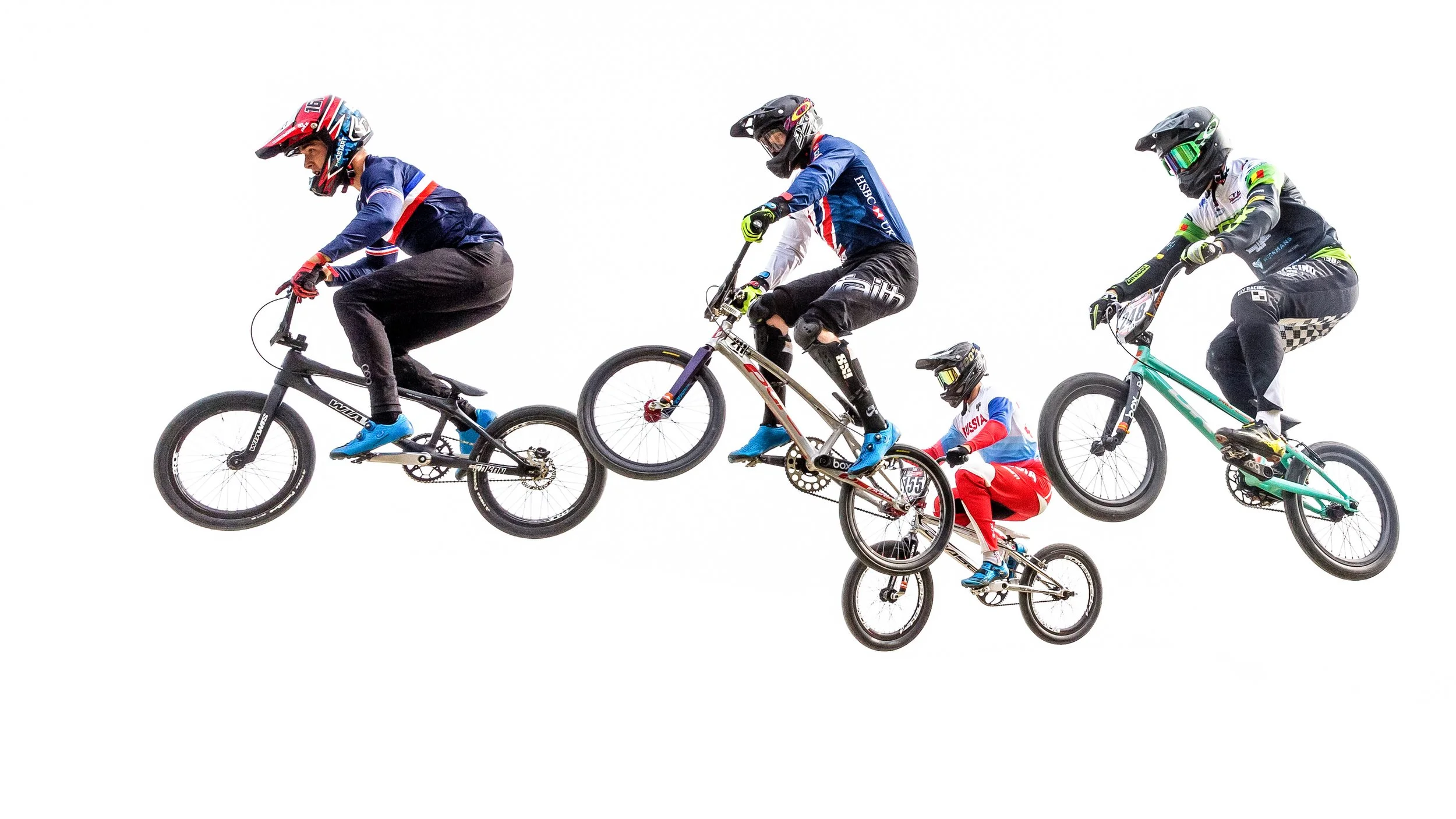 Five cyclists performing a stunt by balancing on their bikes in mid-air against a plain white background.