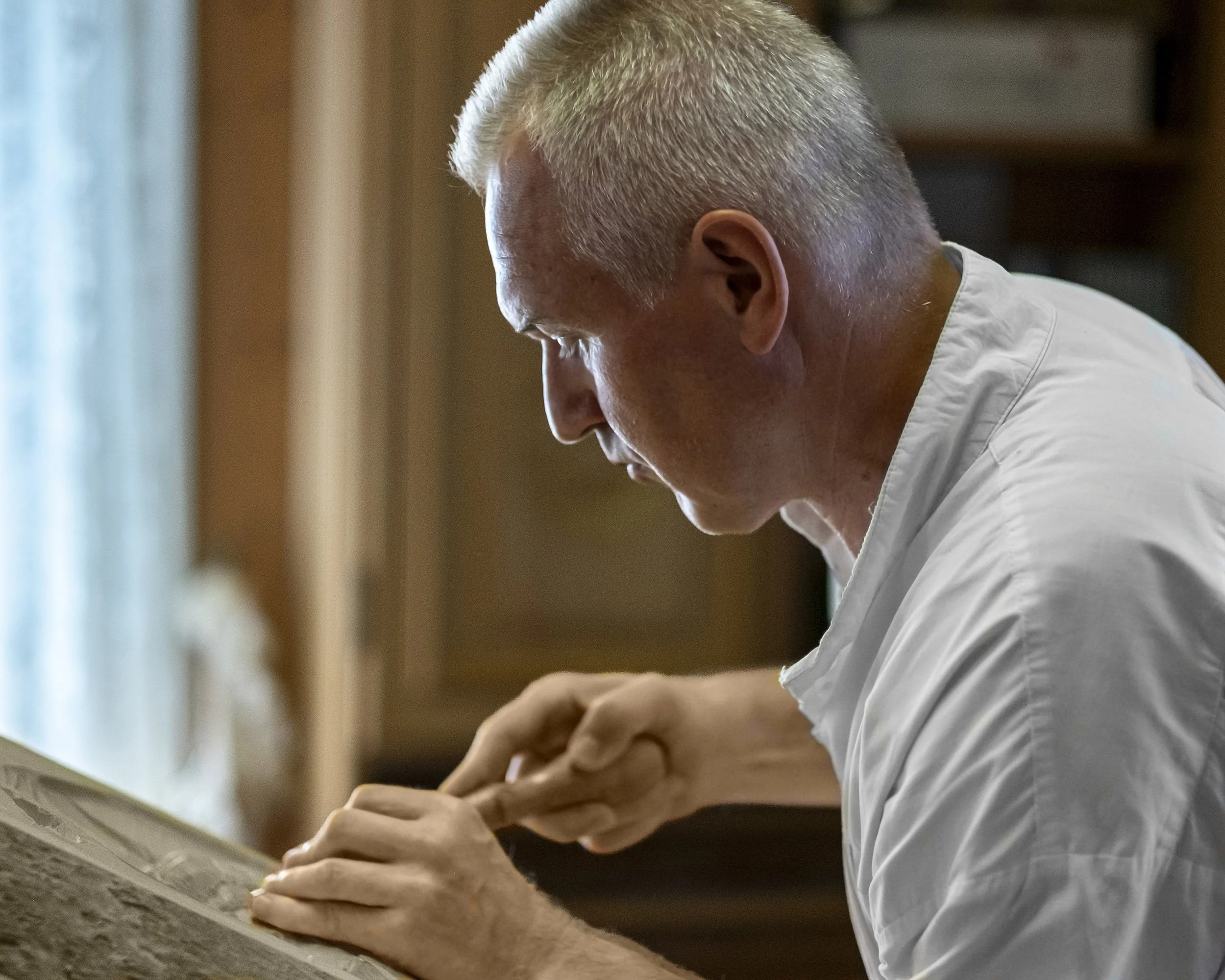 wood crafter working on his art piece
