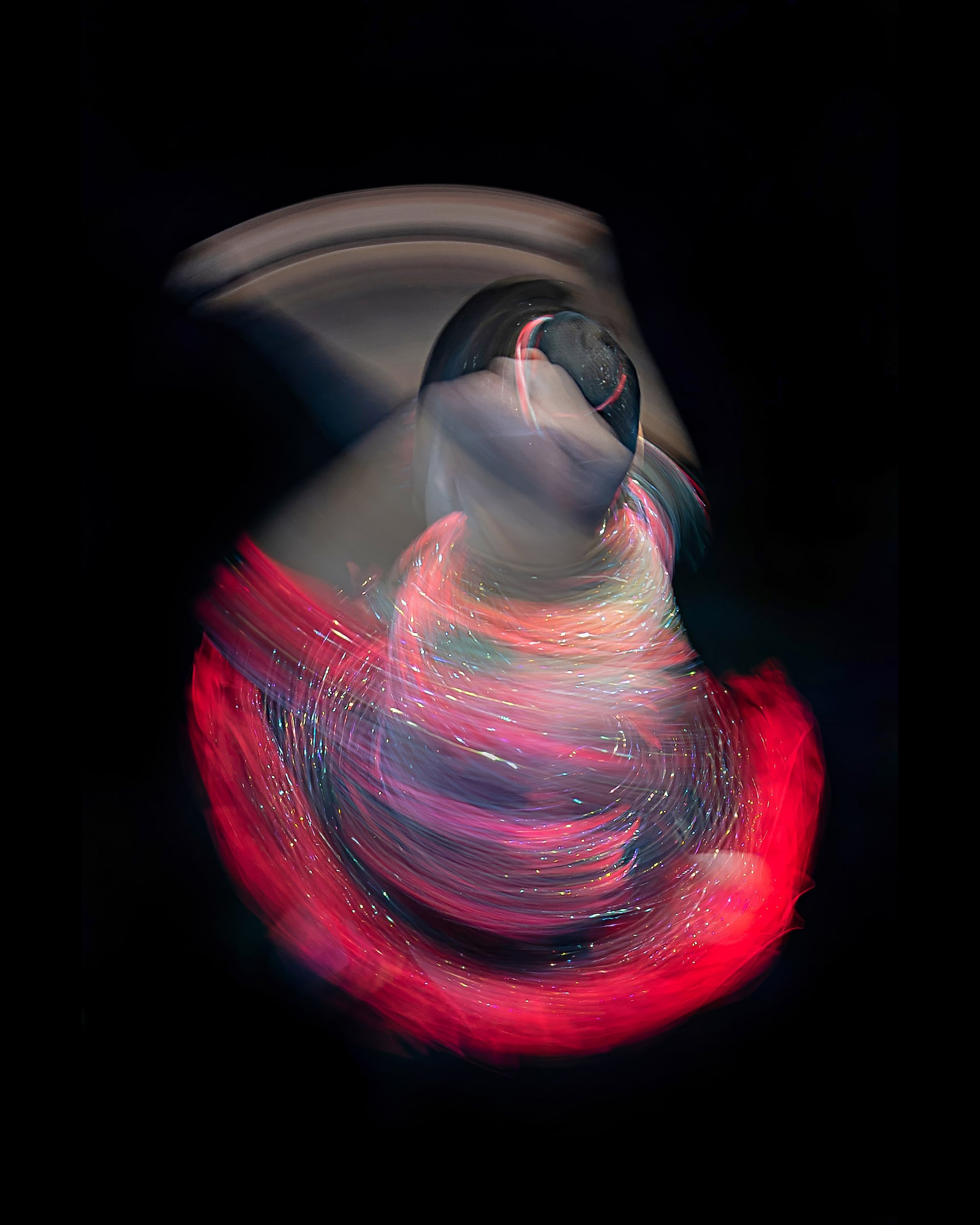 Title: Twisting round and round. 
A long exposure photograph of a female acro gymnast. 
World Championships Acro Gymnastics 2018, Antwerp (Belgium)