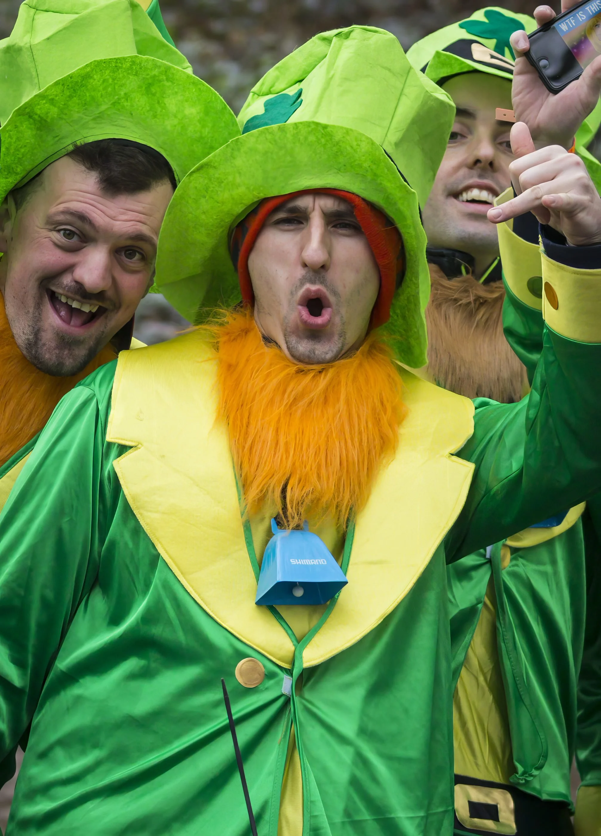 Group of people dressed as carrots, taking a selfie.