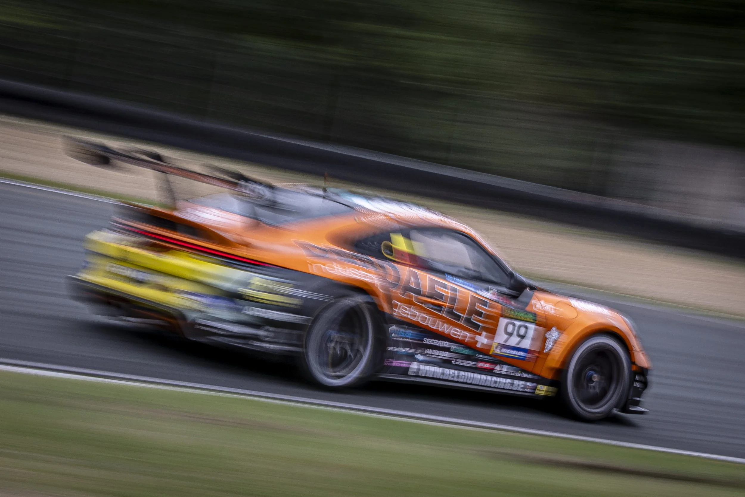 A racing car speeding on a track, with motion blur indicating high speed.