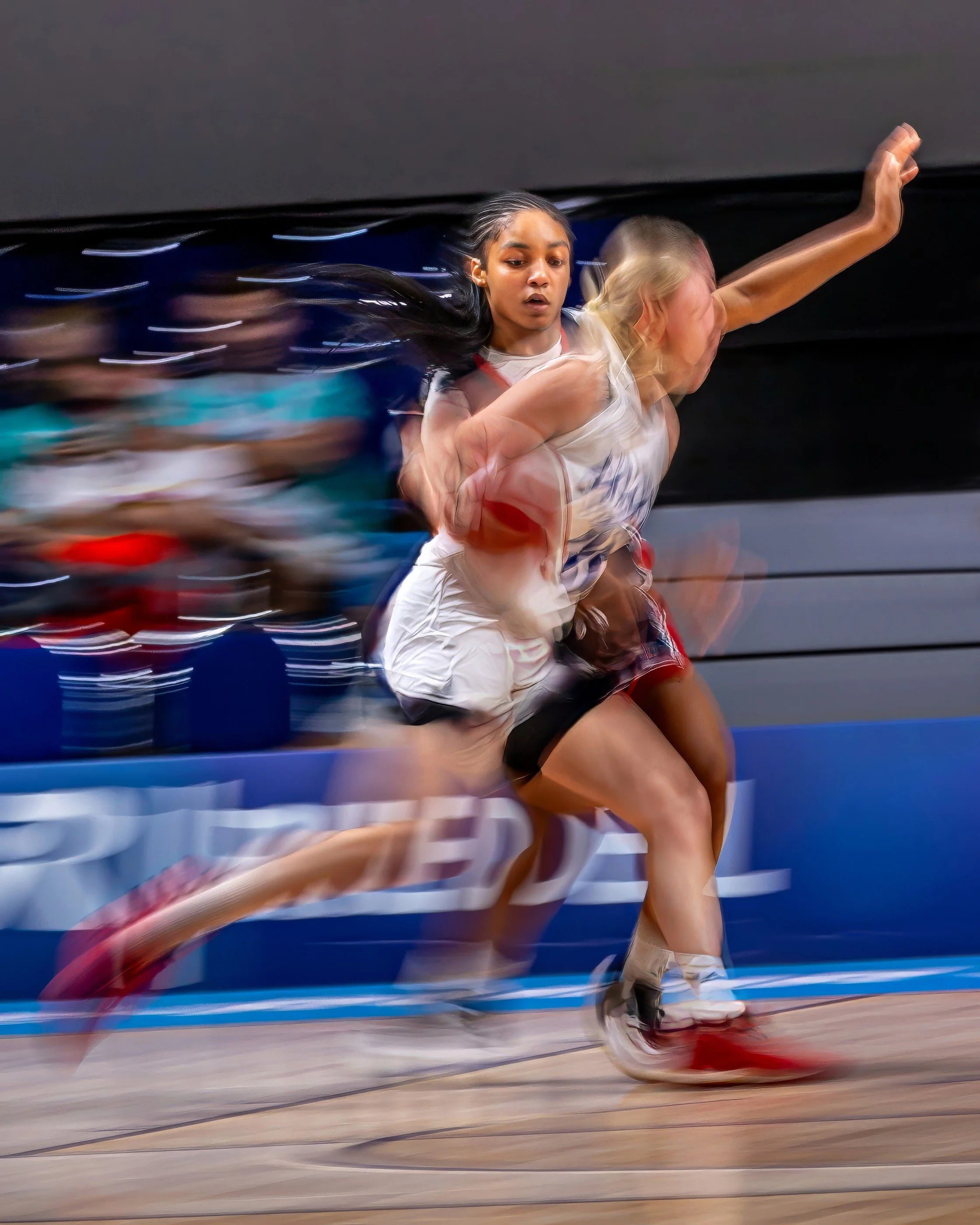 A female athlete running on a track during a race.