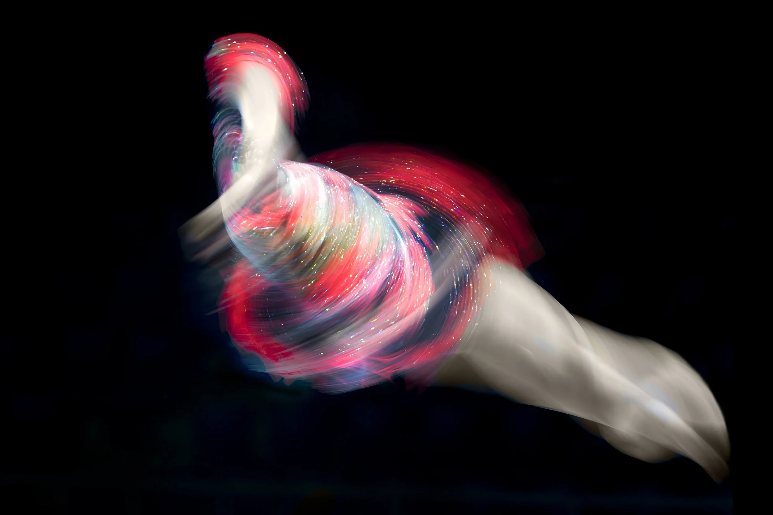 Female acro gymnast photographed with 1 second exposure.