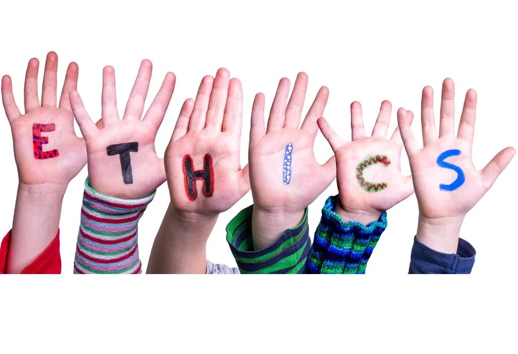 Six children's hands raised with colorful letters on their palms spelling 'E T H I C S'.