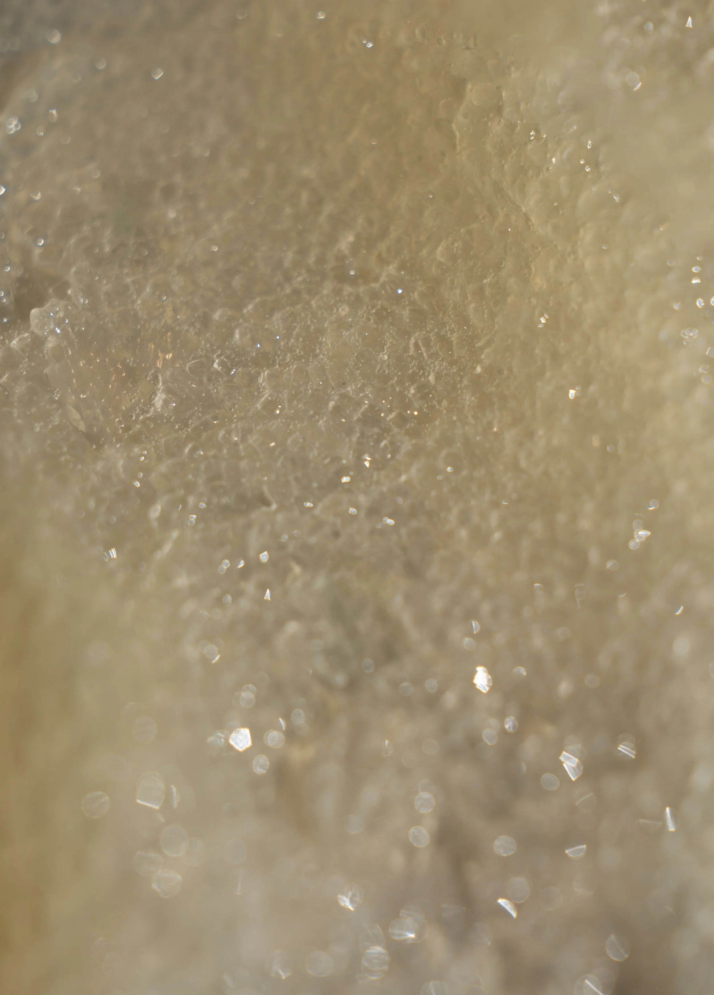 Solace - Sparkling water droplets on sandy beach texture - TVS (1).jpg