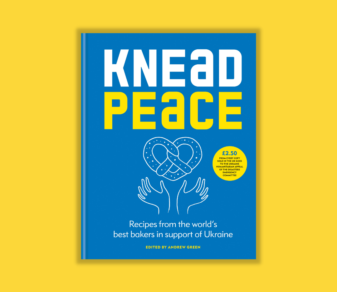 Cover of a book titled "Knead Peace" with a blue background, featuring an illustration of a pretzel and two hands underneath, and a yellow sticker indicating a donation for Ukraine support.