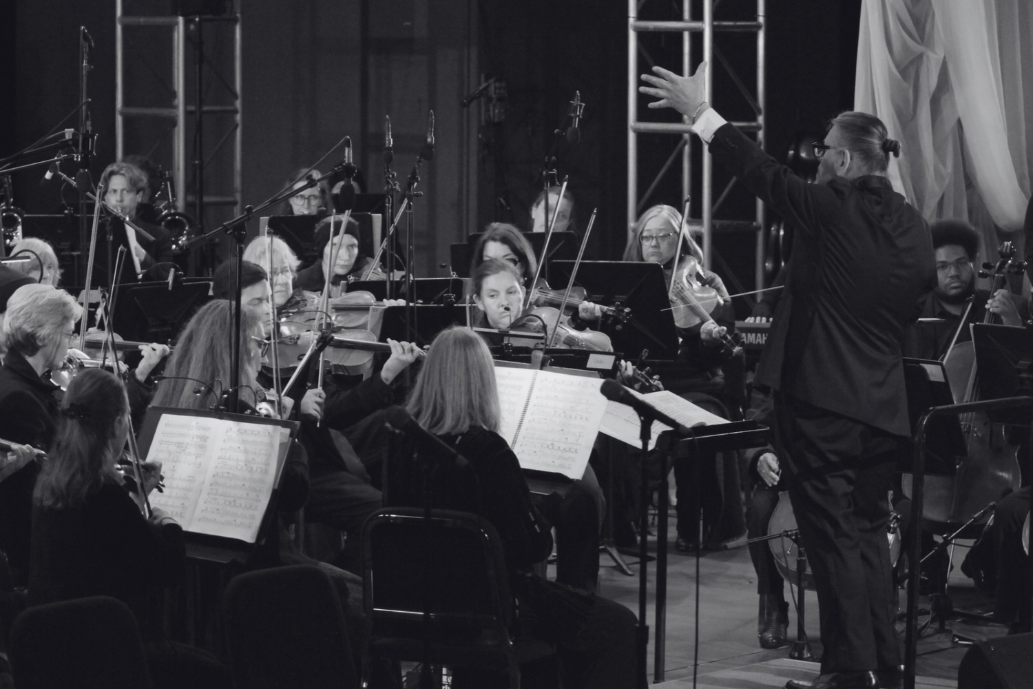 Daniel Henriks conducting an orchestra in performance at the Forest Theater in Carmel, California.