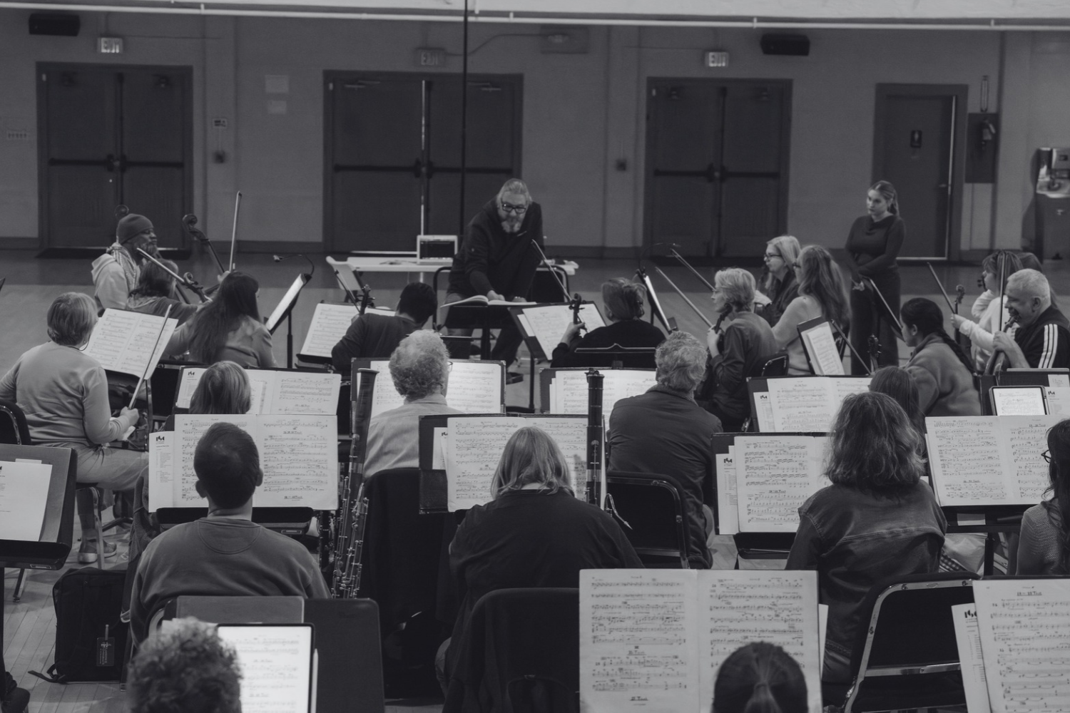Daniel Henriks working with orchestral musicians during rehearsal.