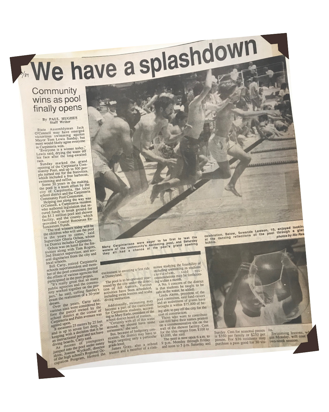 Black and white newspaper article titled "We have a splashdown" with a photo of children jumping into a swimming pool during a community grand opening celebration.
