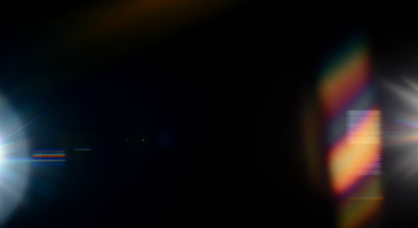 A black background with colorful light flares and reflections, including rainbow hues and bright white bursts on the left and right sides.