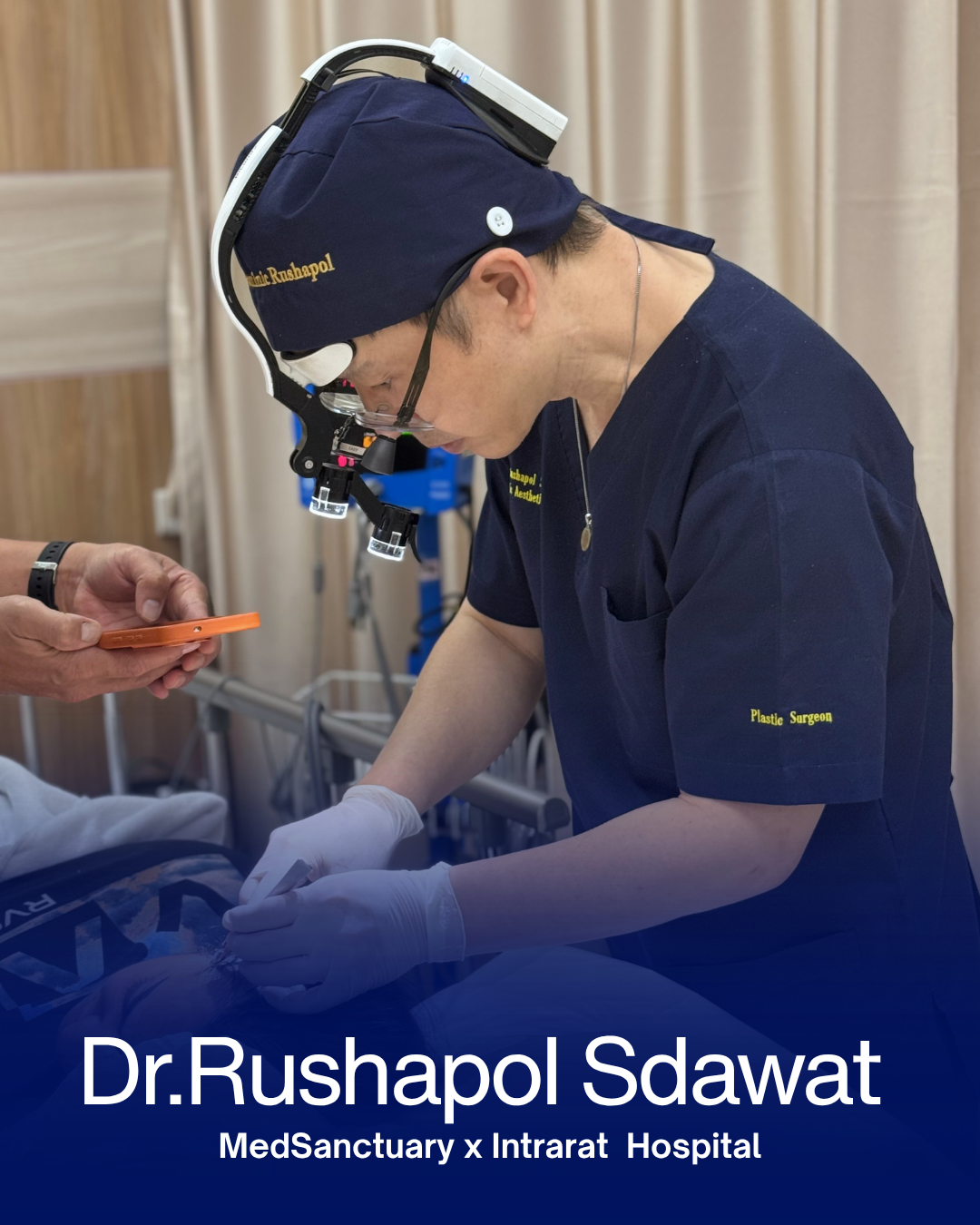 Plastic surgeon Dr. Rushapol Sdawat operating with surgical loupes, MedSanctuary x Intrarat Hospital