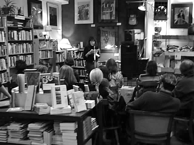 Author reading from this book to a group of people in a bookstore