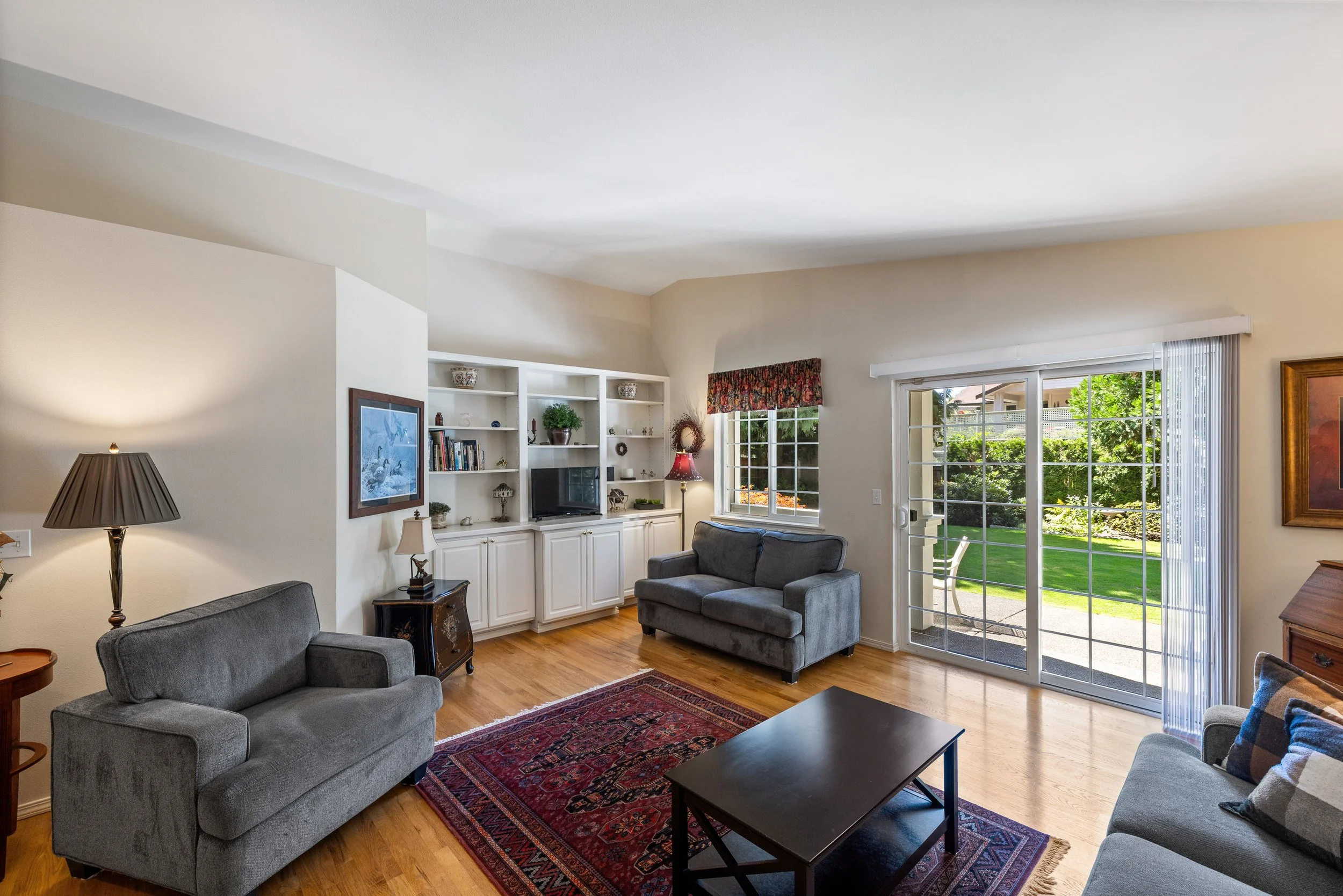 A glass sliding door leads you out to a patio and mature backyard.