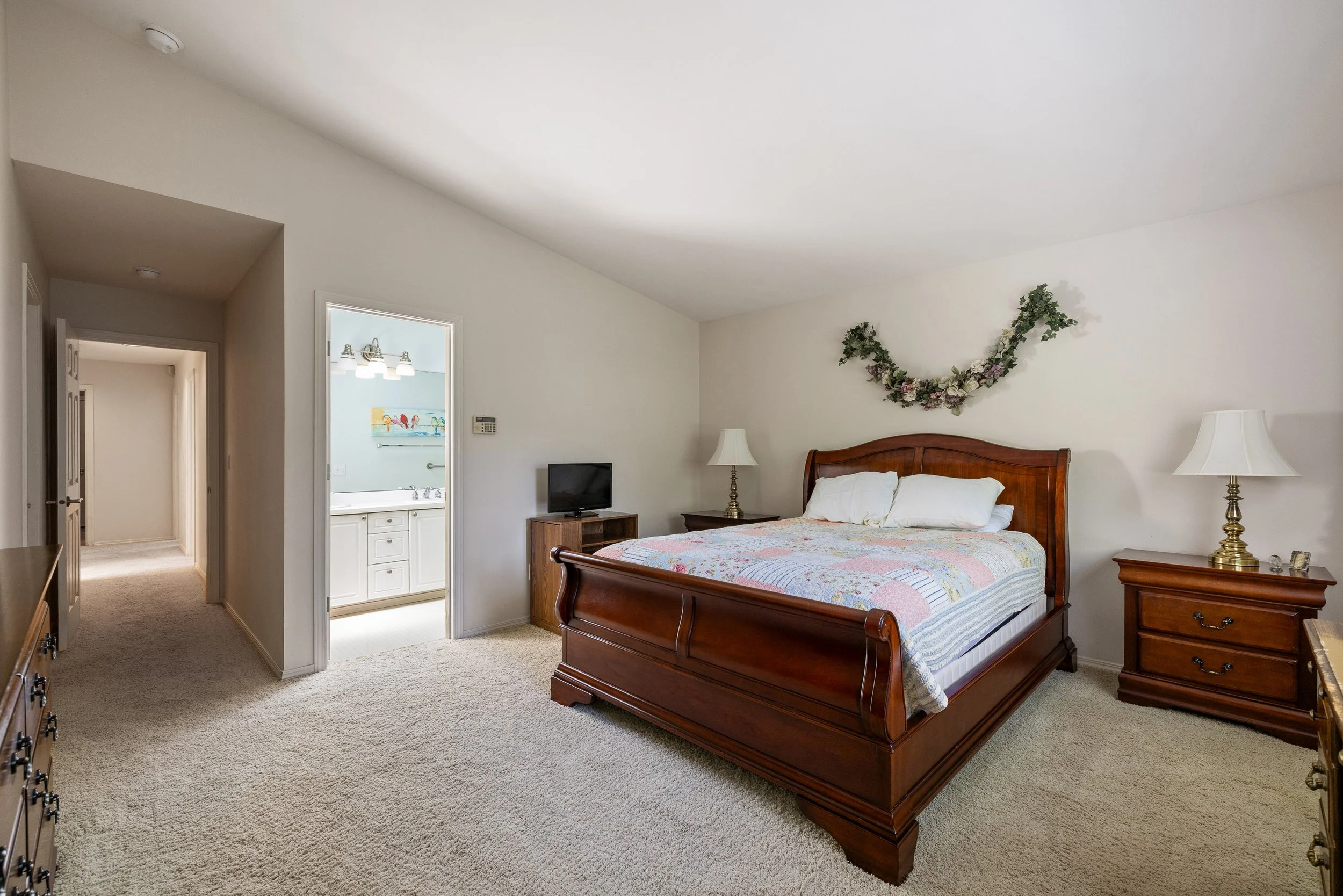 Relax in this large primary with vaulted ceilings and western facing window. 