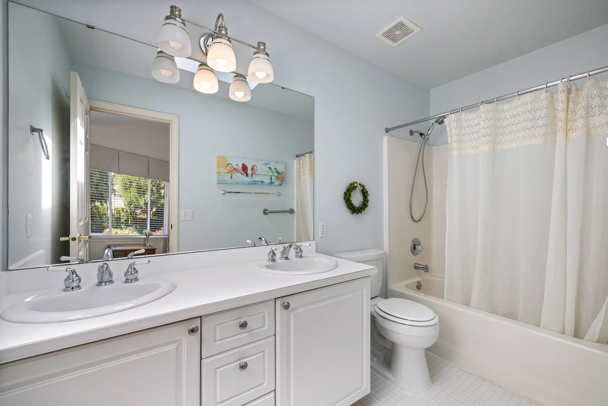 A primary en suite with natural light pouring from the skylight above. 