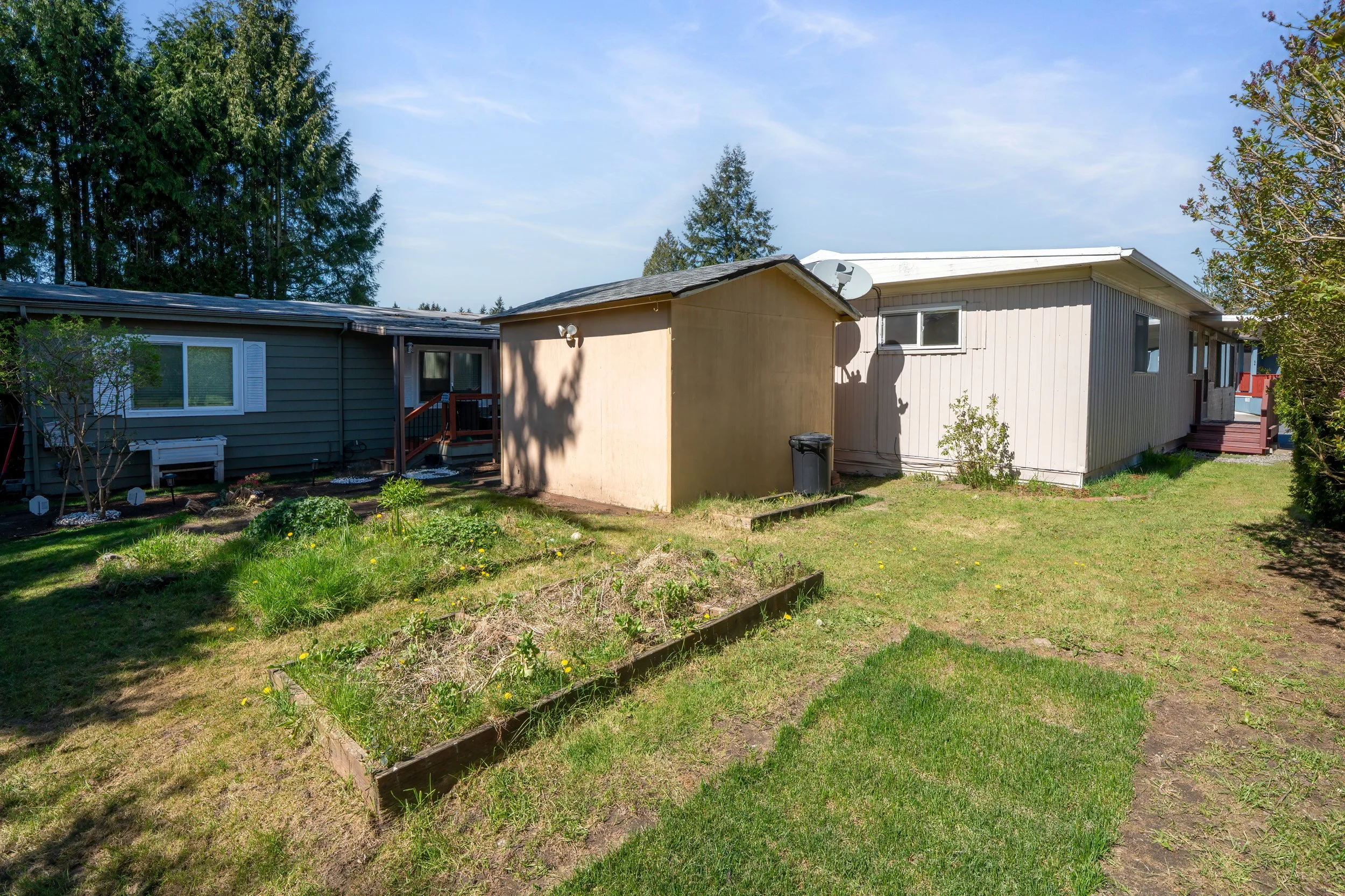 Raised garden beds and a detached shed for extra yard storage.
