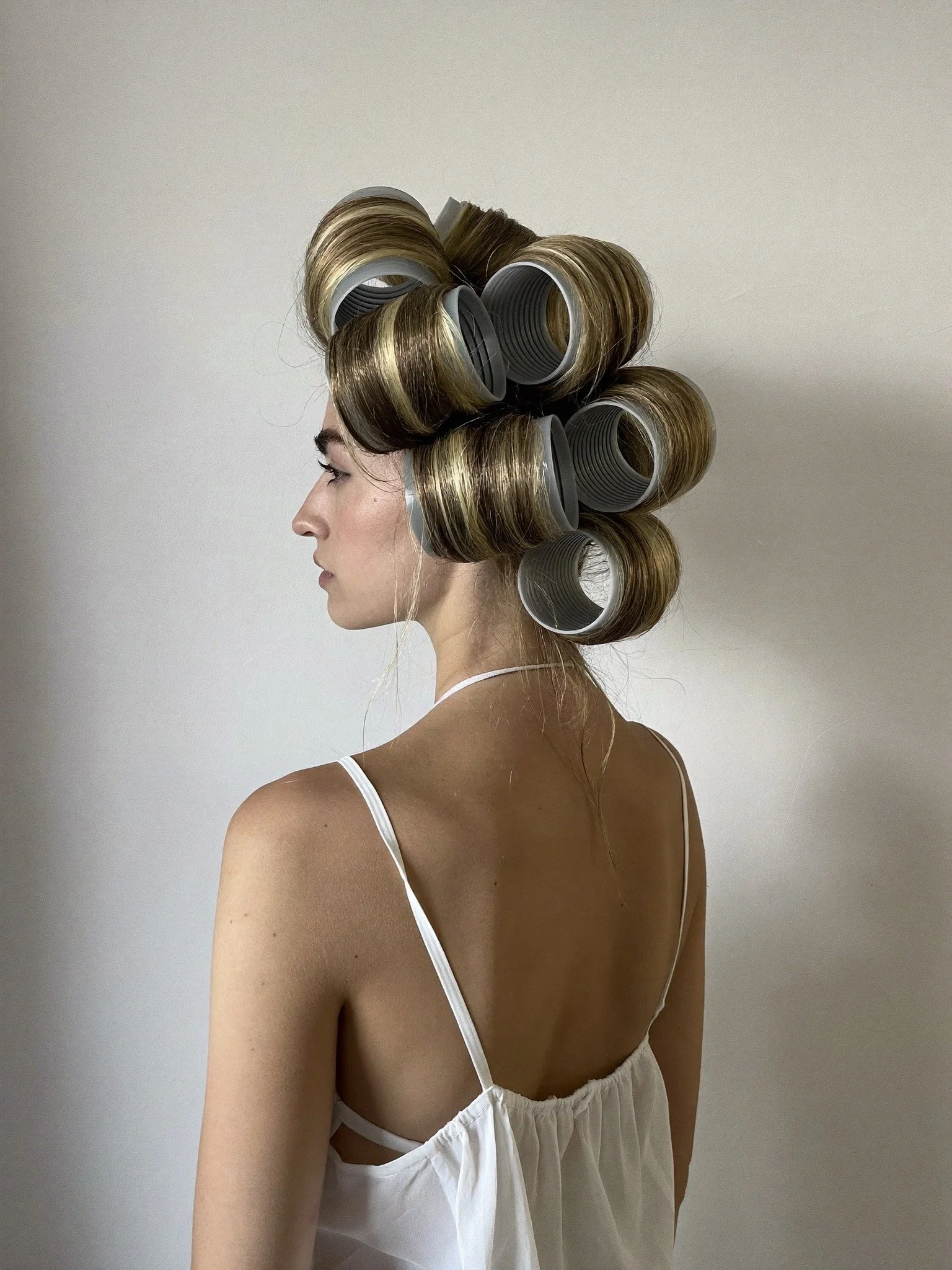 Tresses - Woman with hair rollers in profile against neutral background - TVS.jpg