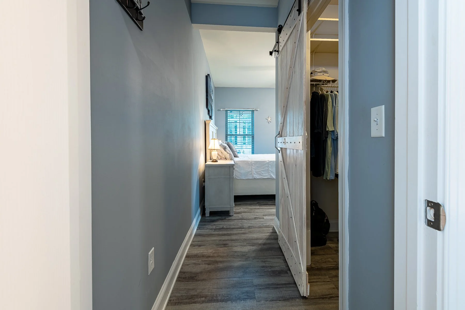 Primary-suite hallway with sliding barn door and walk-in closet at 28839 W Henry Place.