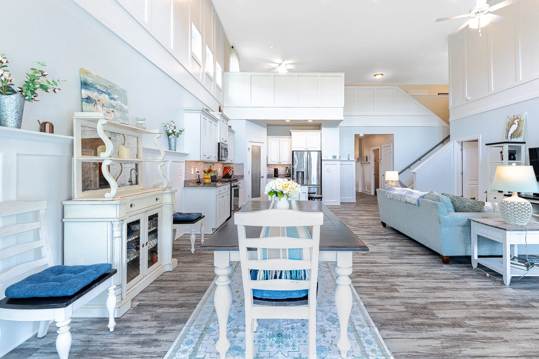 Dining area and open kitchen with soaring ceiling and custom trim at 28839 W Henry Place.