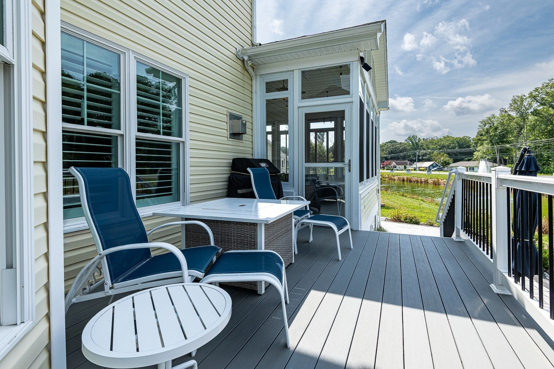 Outdoor deck seating beside the screened porch at 28839 W Henry Place.