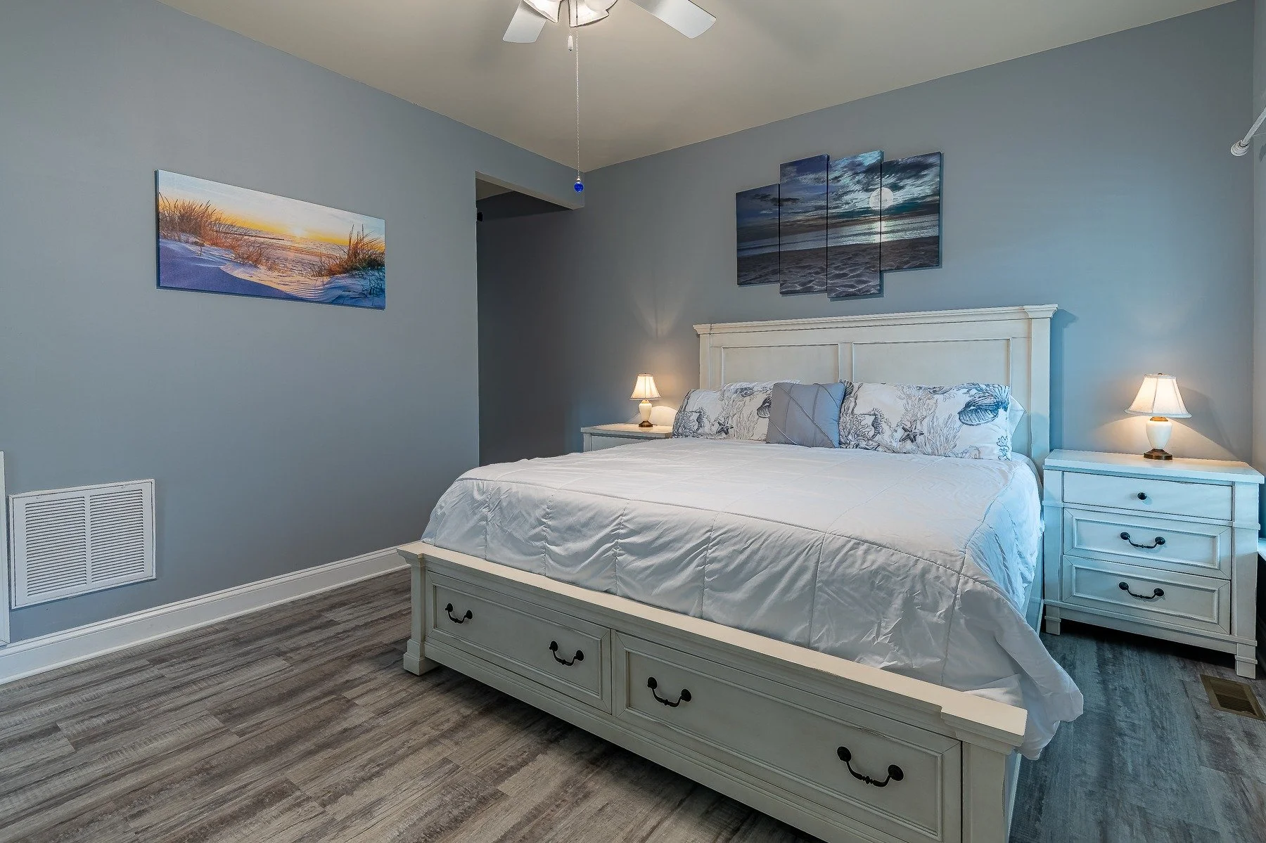 Primary bedroom with coastal decor and luxury vinyl flooring at 28839 W Henry Place.