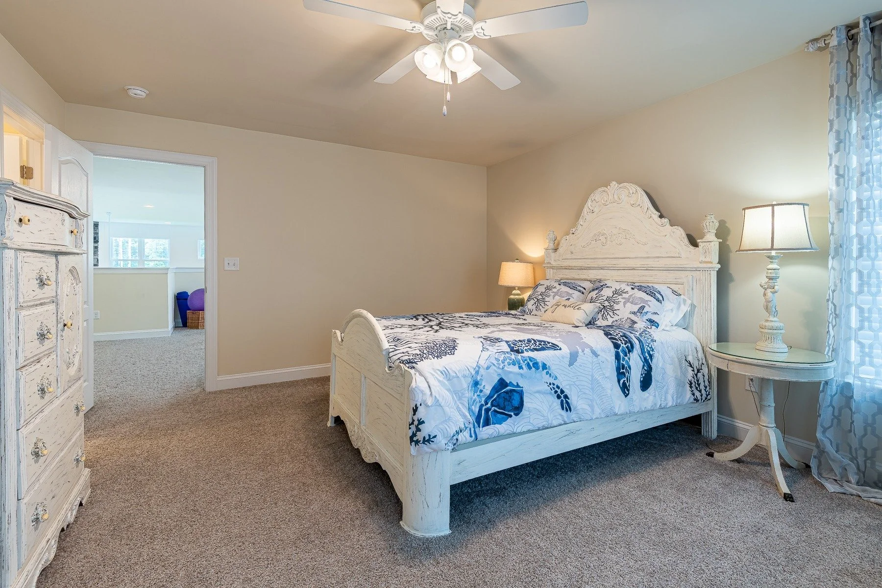 Upstairs bedroom with coastal furnishings and loft access at 28839 W Henry Place.