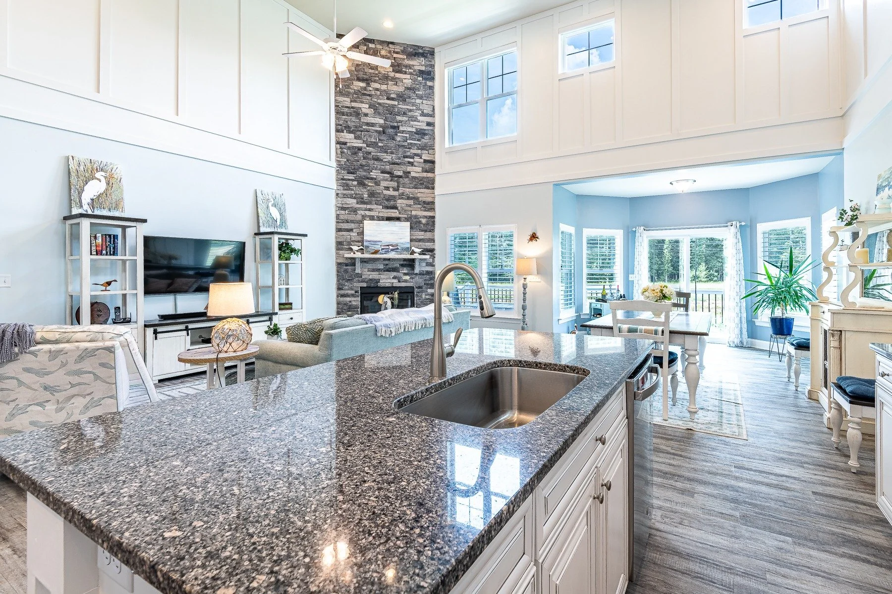 Granite kitchen island overlooking the two-story great room and stone fireplace at 28839 W Henry Place.