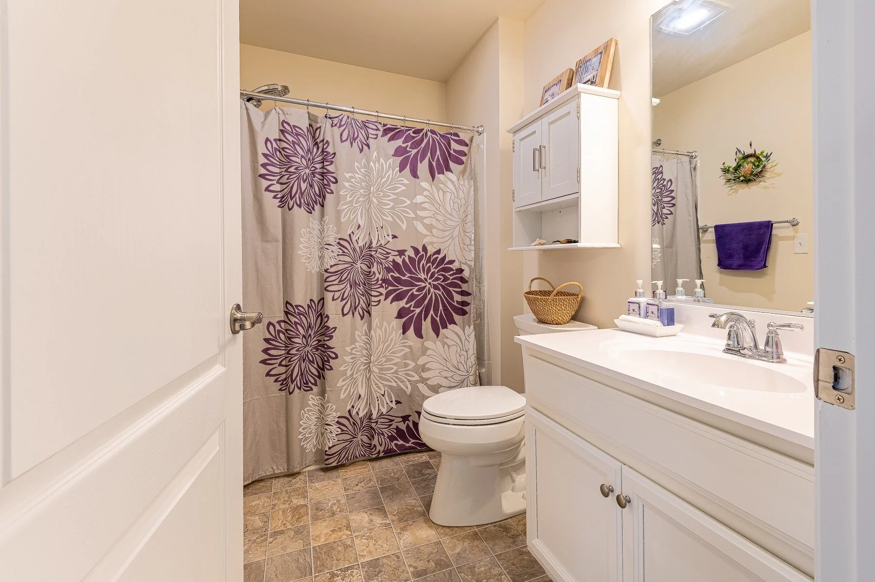 Upstairs full bathroom with white vanity and tub-shower combination at 28839 W Henry Place.