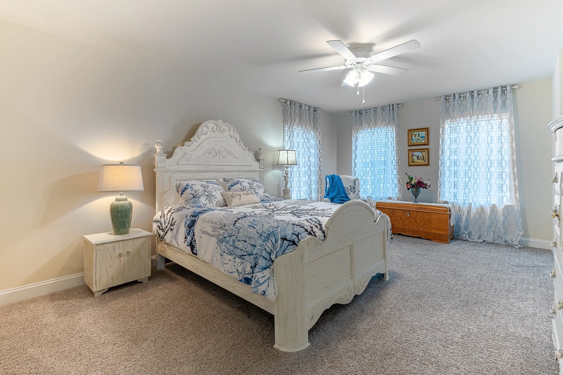 Spacious upstairs bedroom with coastal decor and abundant windows at 28839 W Henry Place.