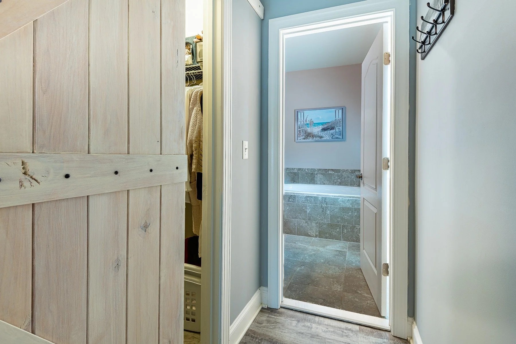 Barn-door entry to the primary closet and bathroom at 28839 W Henry Place.