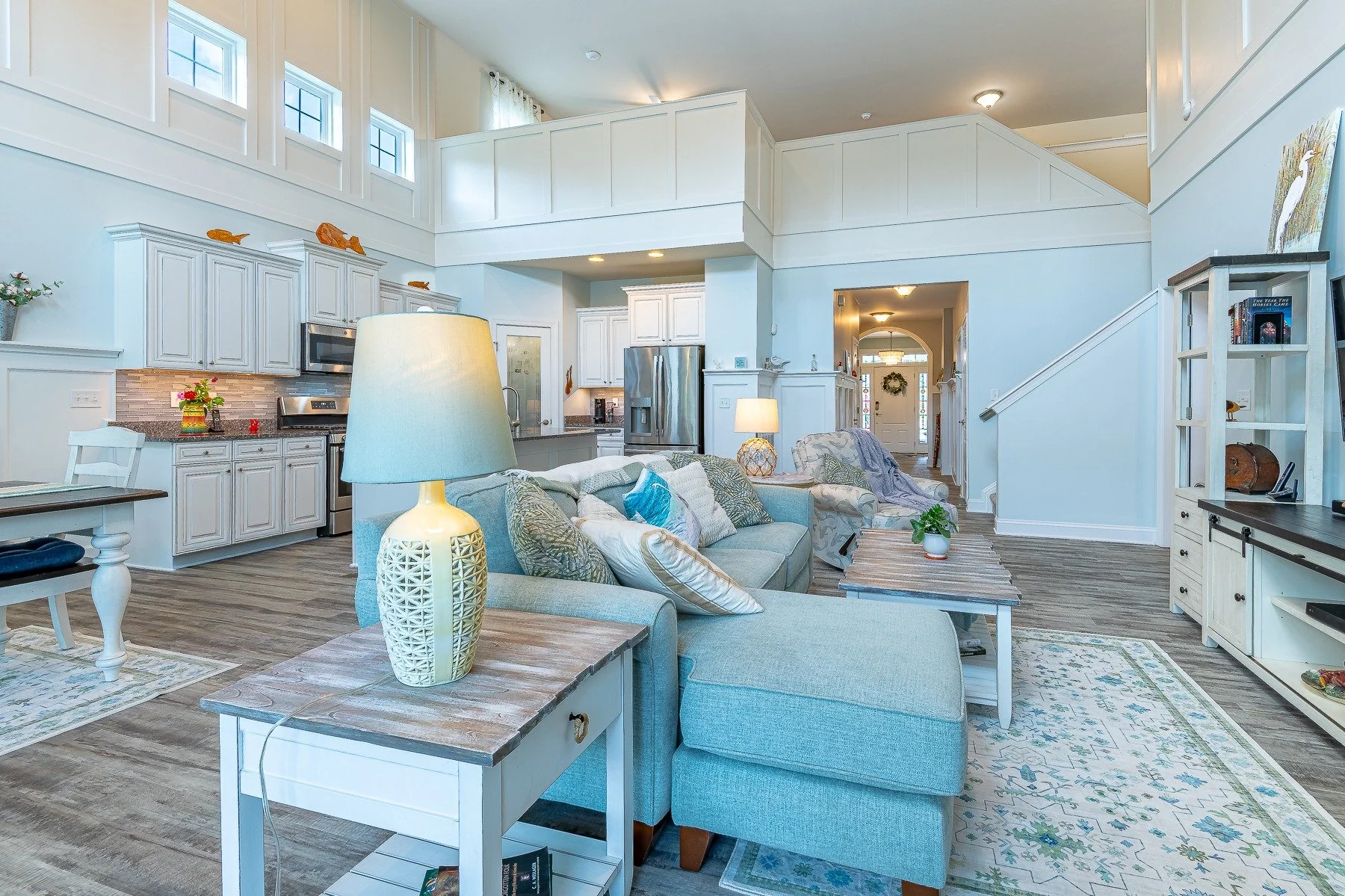 Open living room and kitchen viewed toward the foyer and staircase at 28839 W Henry Place.