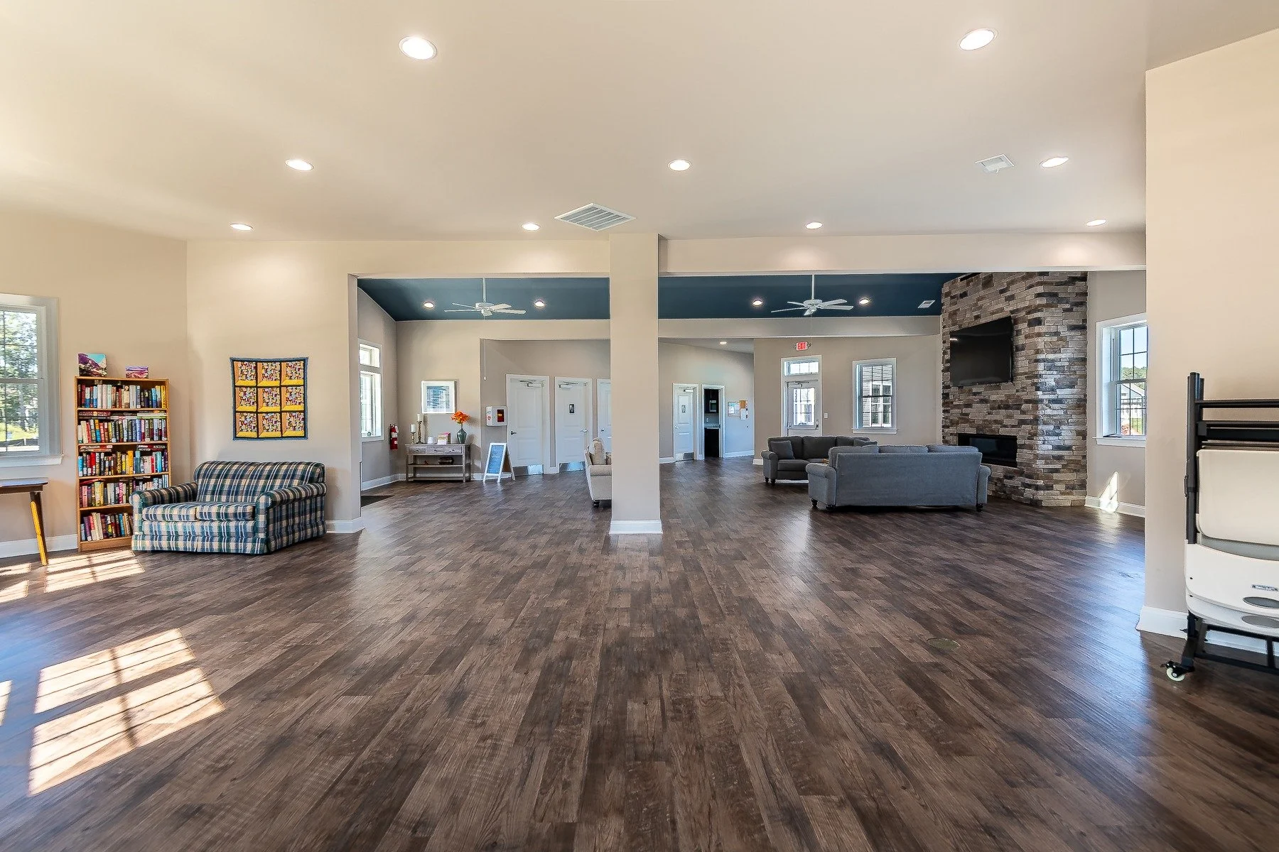 Community clubhouse lounge with stone fireplace.