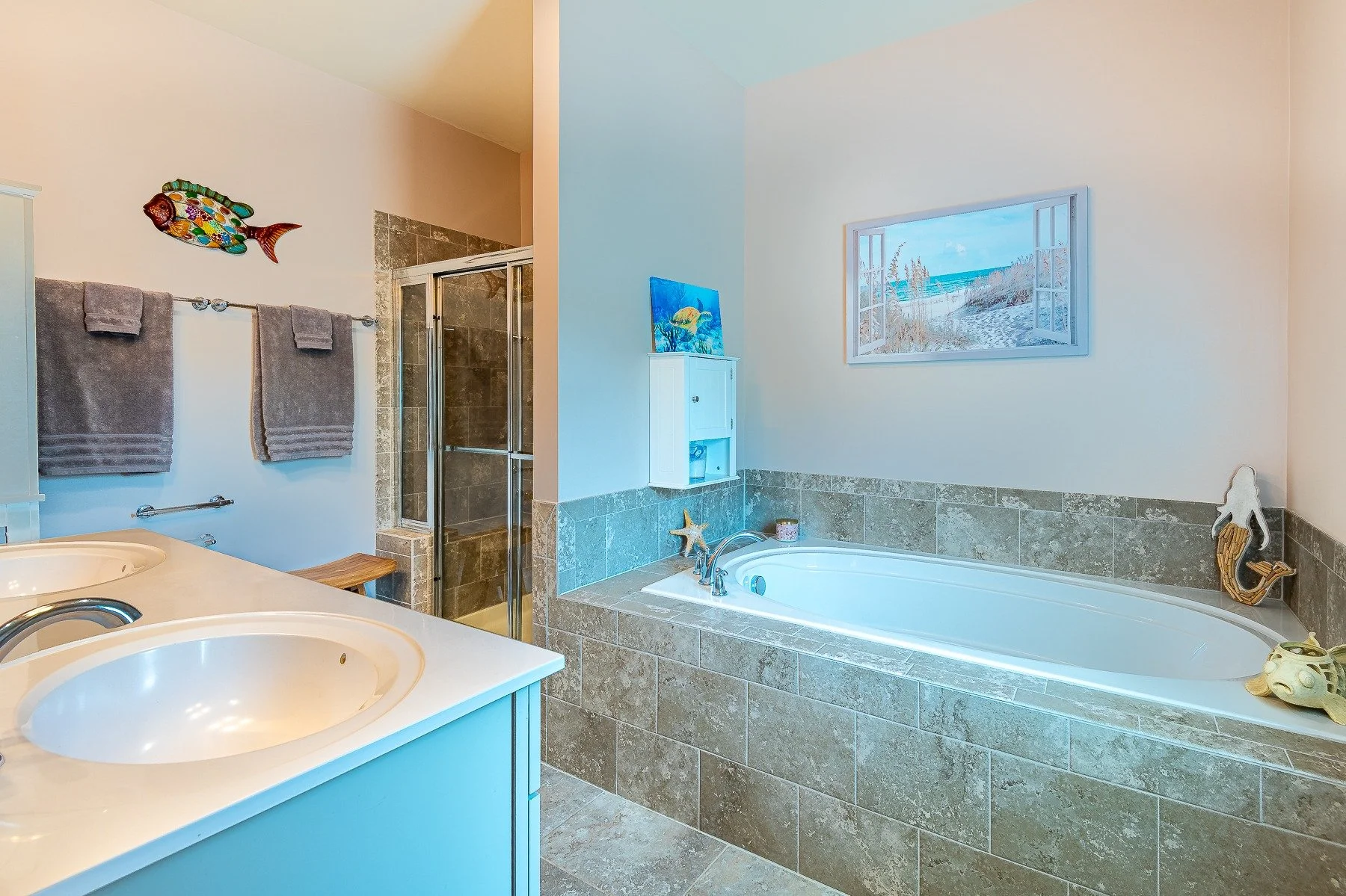 Primary bathroom with double vanity, soaking tub, and tiled shower at 28839 W Henry Place.