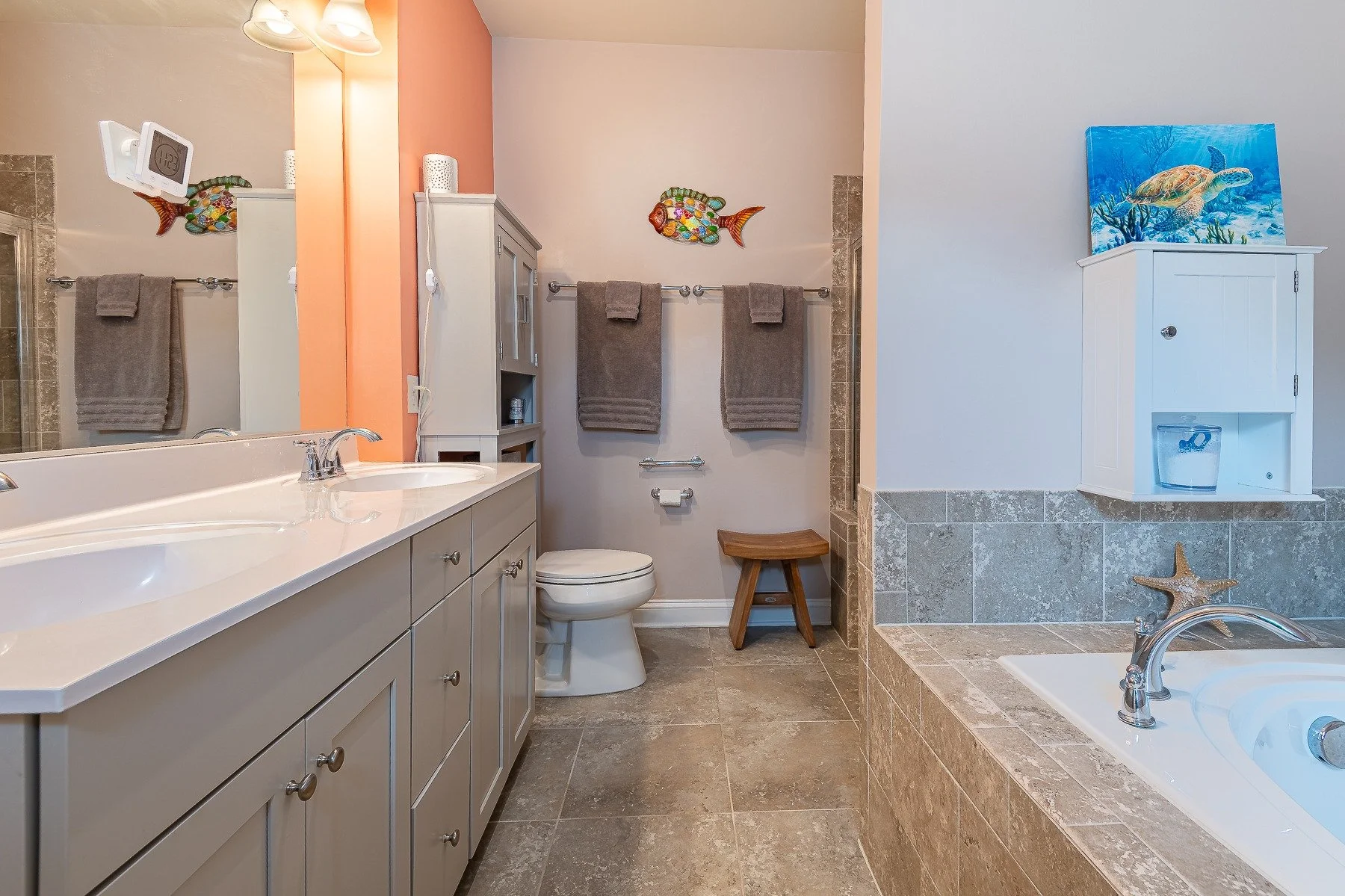 Primary bathroom with double vanity and coastal details at 28839 W Henry Place.