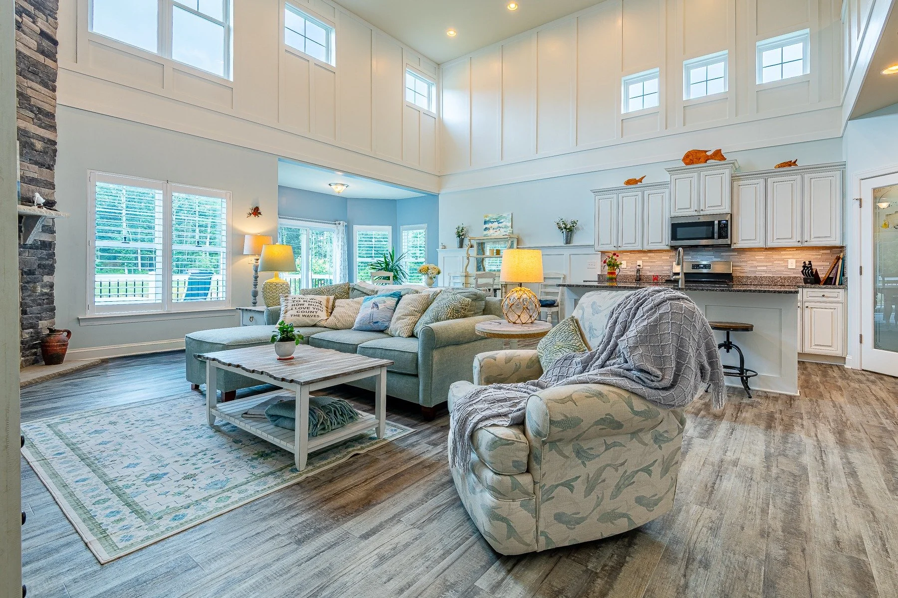 Two-story living room with abundant windows and open kitchen at 28839 W Henry Place.