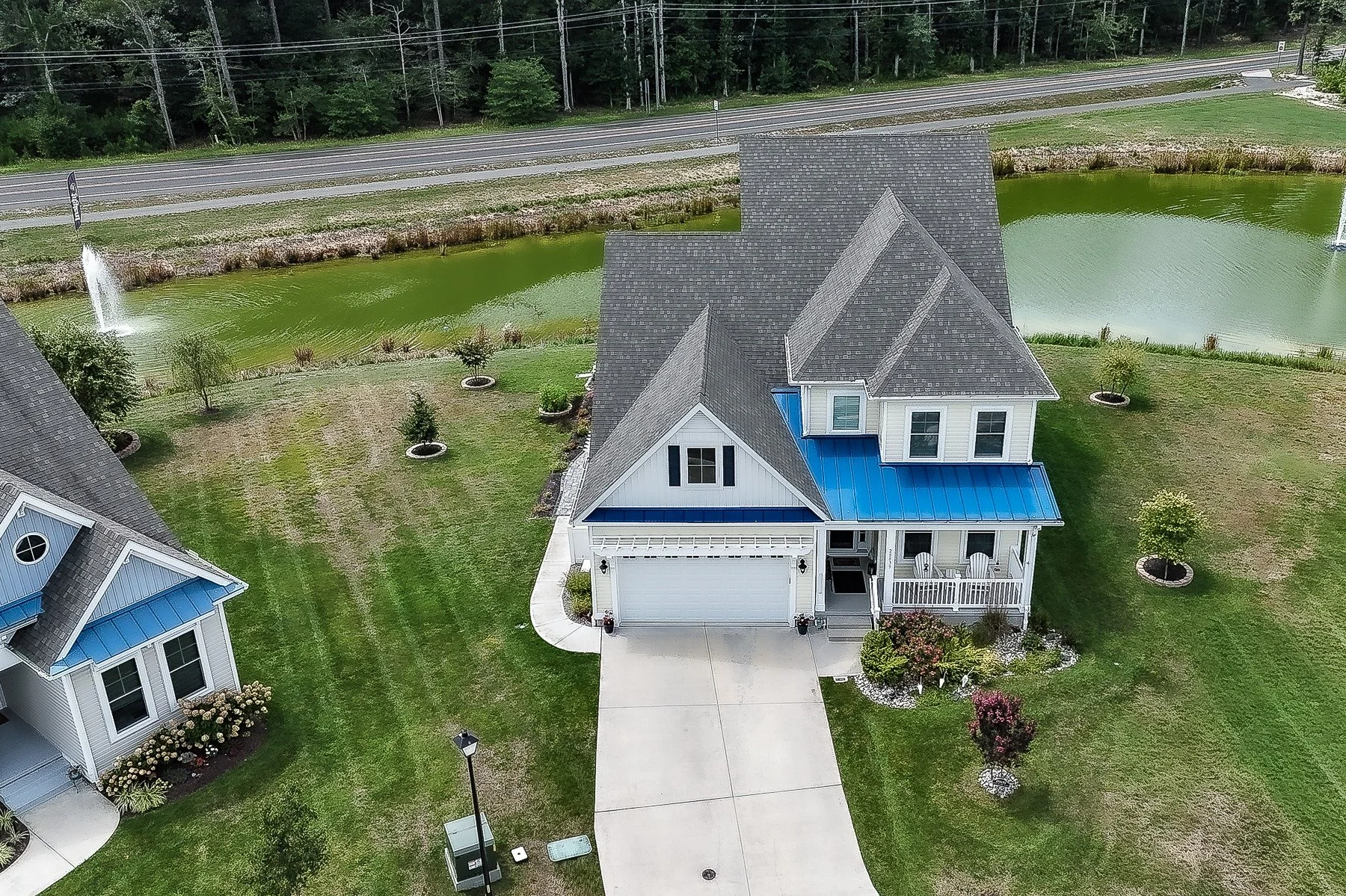 Aerial front view of 28839 W Henry Place beside the community pond.