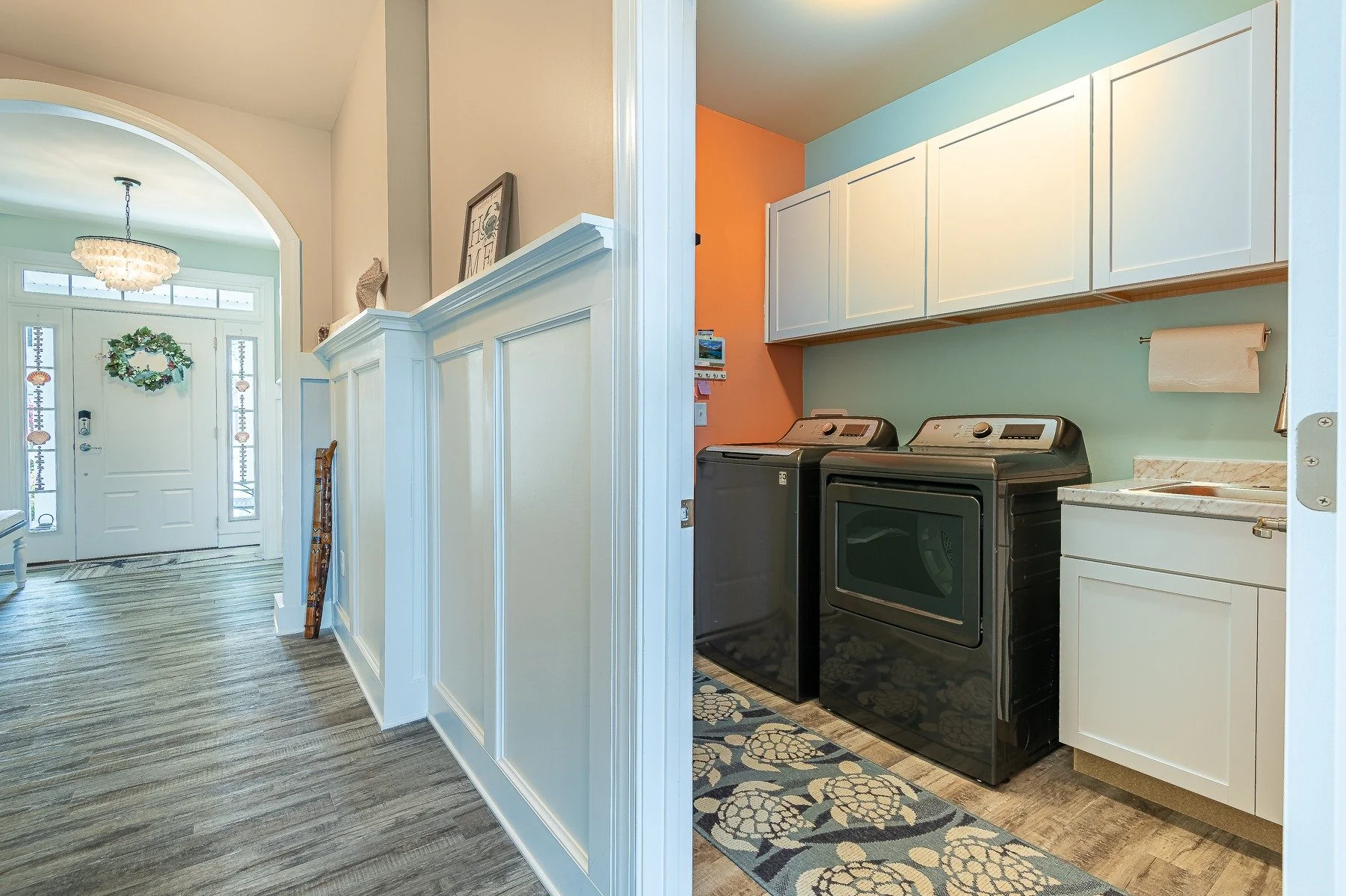 Laundry room with cabinetry, utility sink, washer, and dryer at 28839 W Henry Place.
