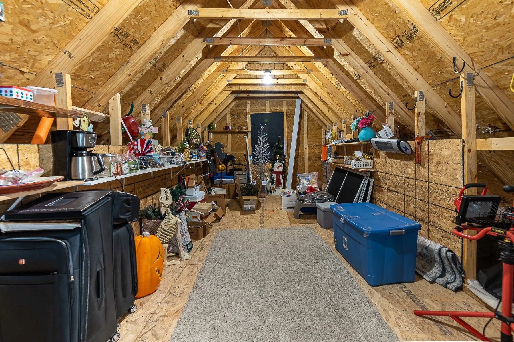 Large unfinished walk-in storage area above the garage at 28839 W Henry Place.