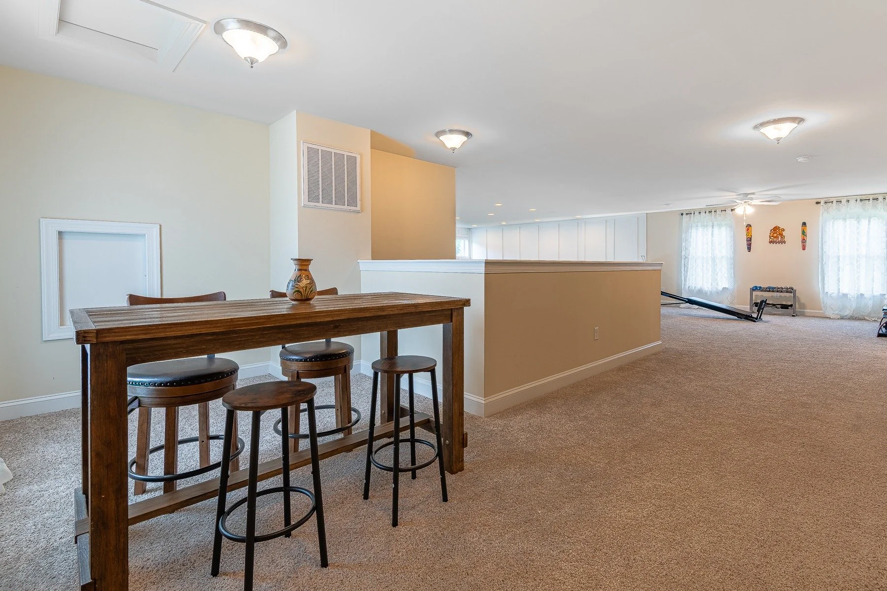 Open loft with dining table and flexible activity space at 28839 W Henry Place.