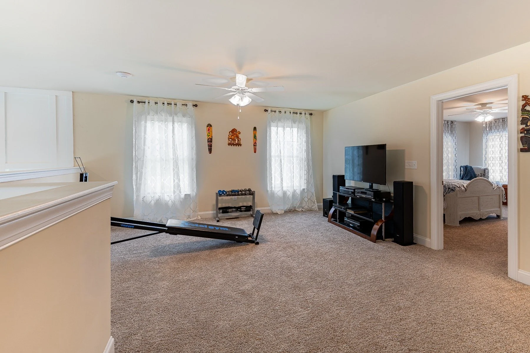 Spacious upstairs loft configured as a media and exercise area at 28839 W Henry Place.
