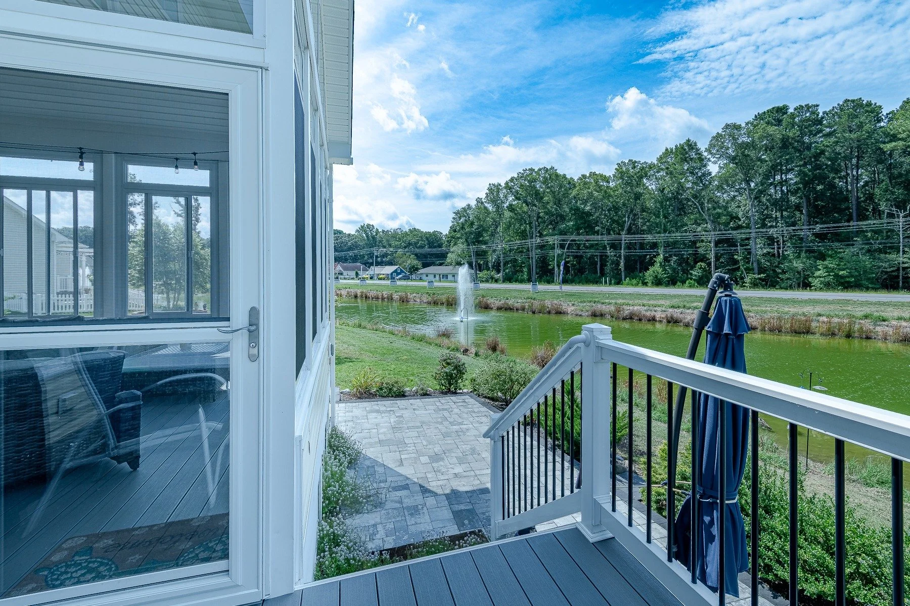 Deck stairs and patio overlooking the pond and fountain at 28839 W Henry Place.